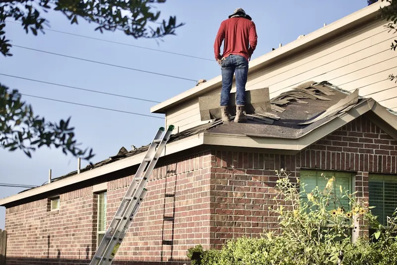 Professional roofer working on a residential roof in Newville